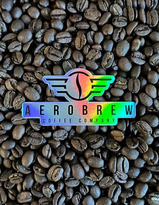 Coffee beans with Aerobrew Coffee Company logo on a wooden surface