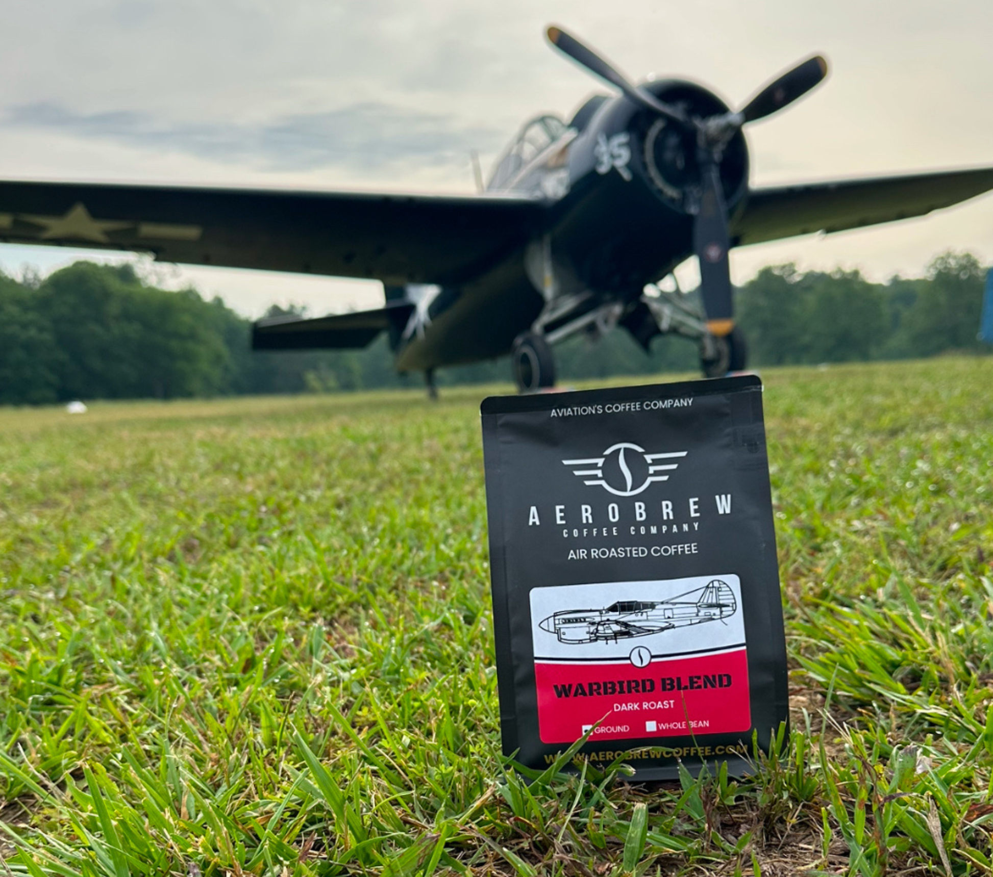 Aeros Brew coffee package in front of a vintage airplane on grass