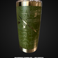 Green tumbler with engraved design on a black background